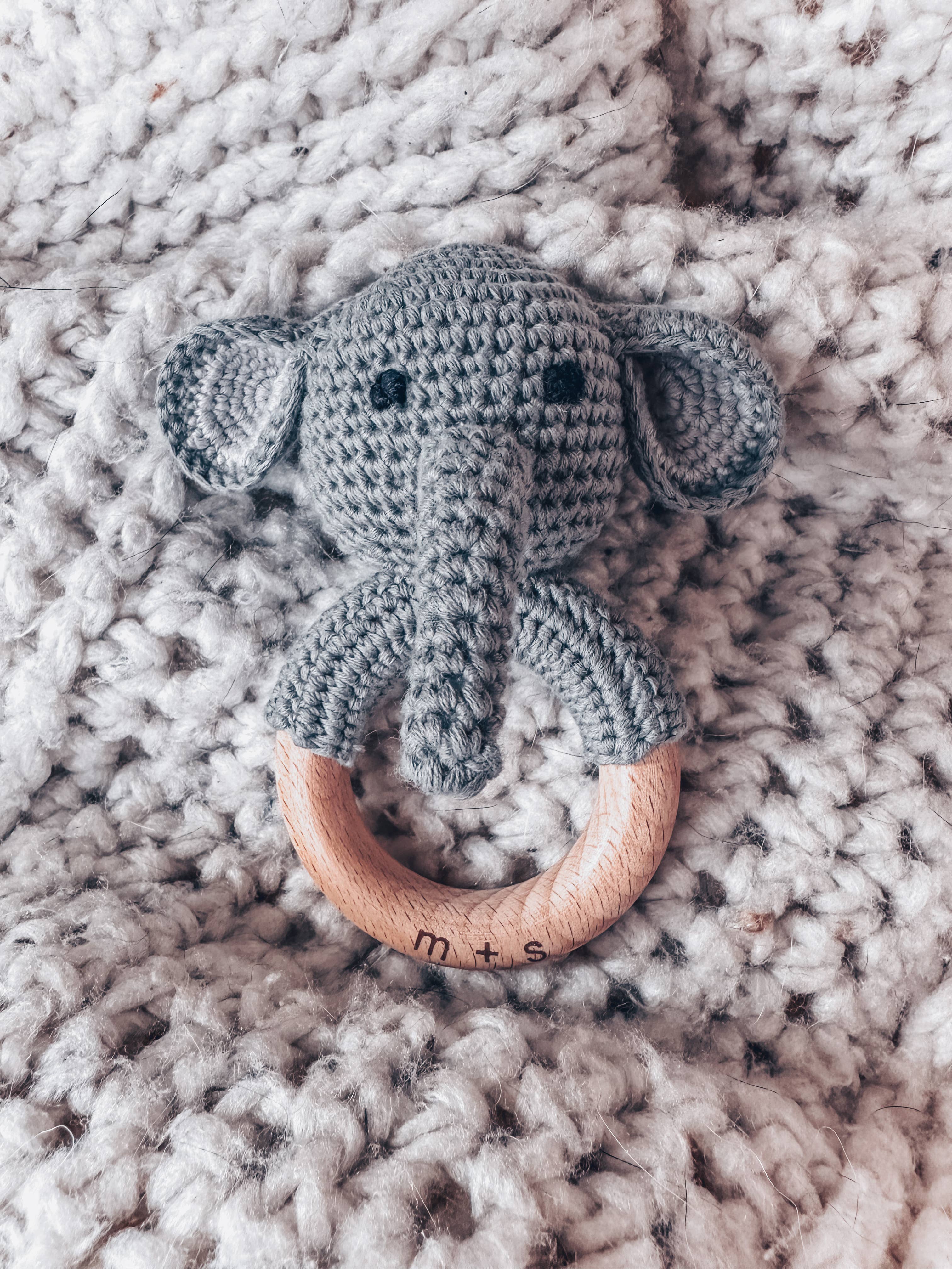 Handmade elephant crochet teether with wooden ring, perfect for sensory play and early development for babies.