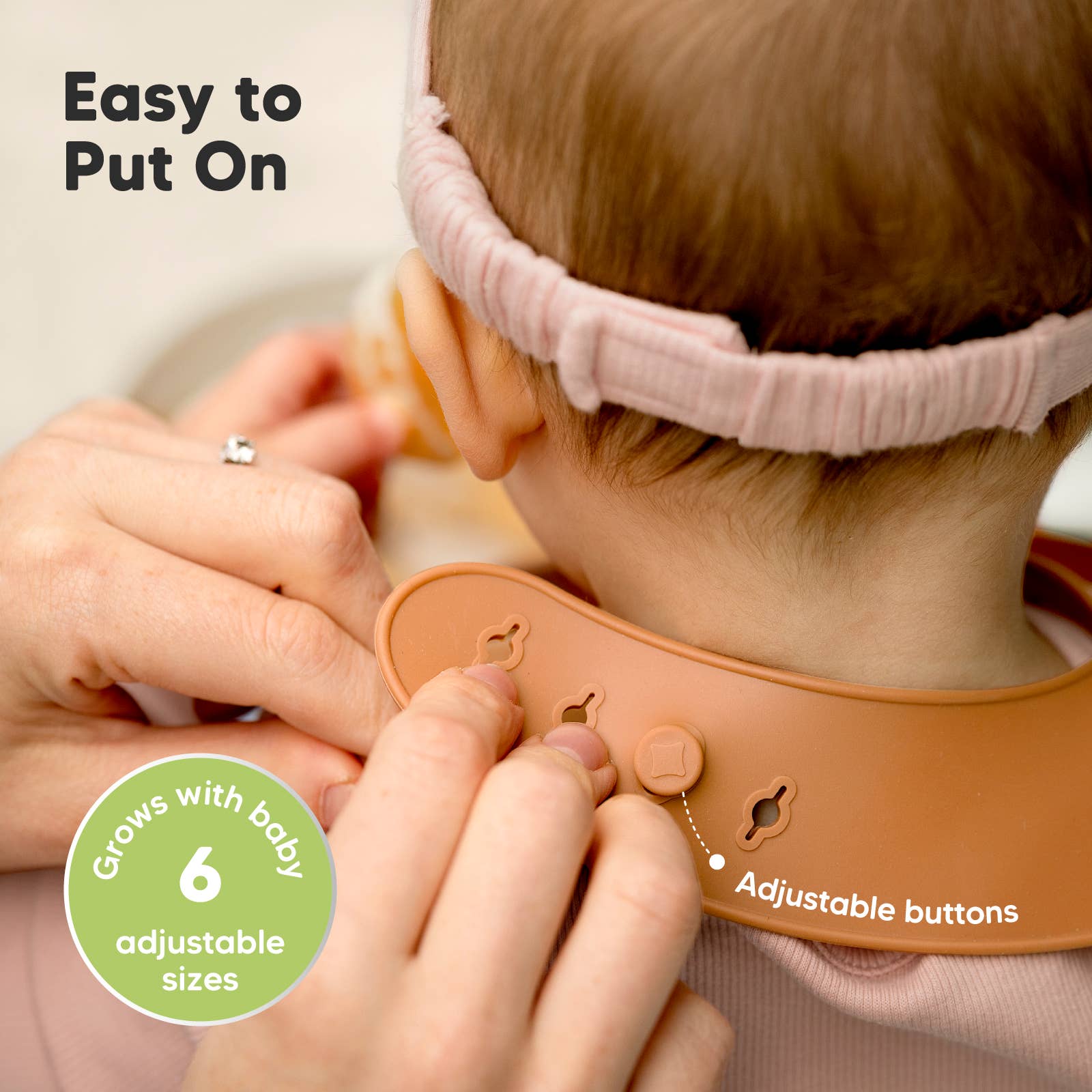Parent adjusting KeaBabies Silicone Bibs on a toddler, highlighting easy-to-use adjustable buttons and comfortable fit for mealtime.