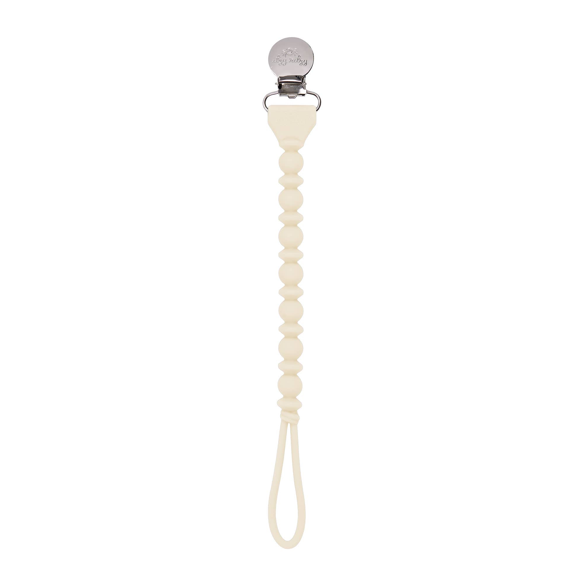 Sweetie Strap™ silicone pacifier clip in cream color, featuring stylish braided design and secure clasp for pacifiers.