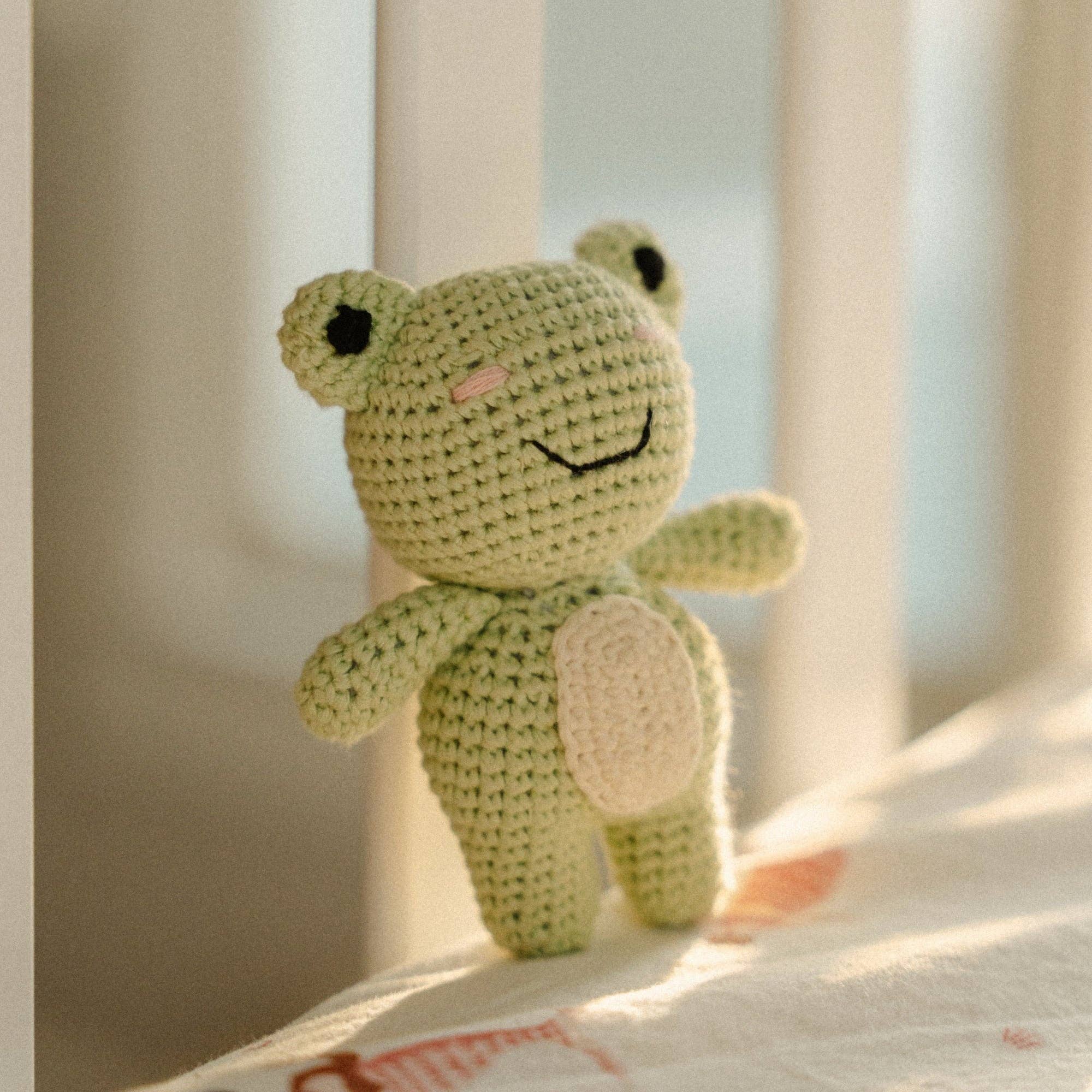 Adorable Georgie the Groggy Froggy crochet toy, perfect for babies and toddlers, featuring a rattle and charming details.