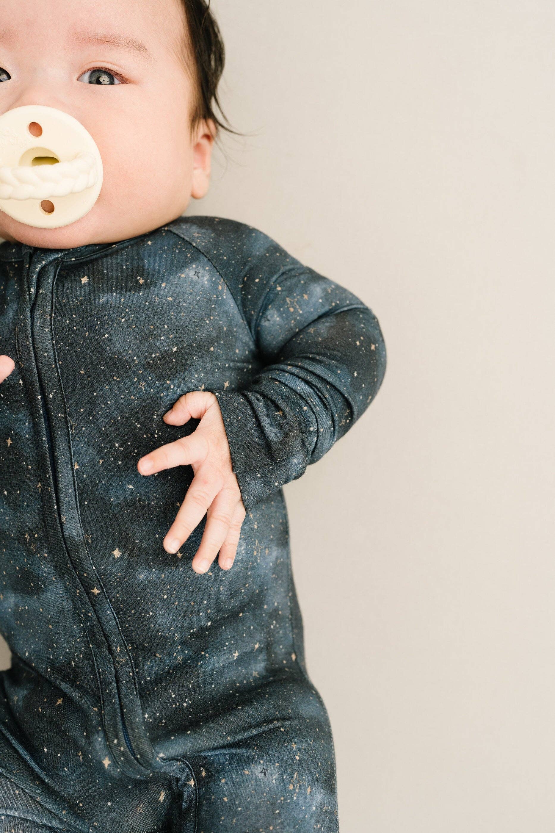 Baby wearing Moonlight Bamboo Sleeper from Little One Shop, 6-12M, made of soft bamboo viscose. Cozy nightwear for infants.