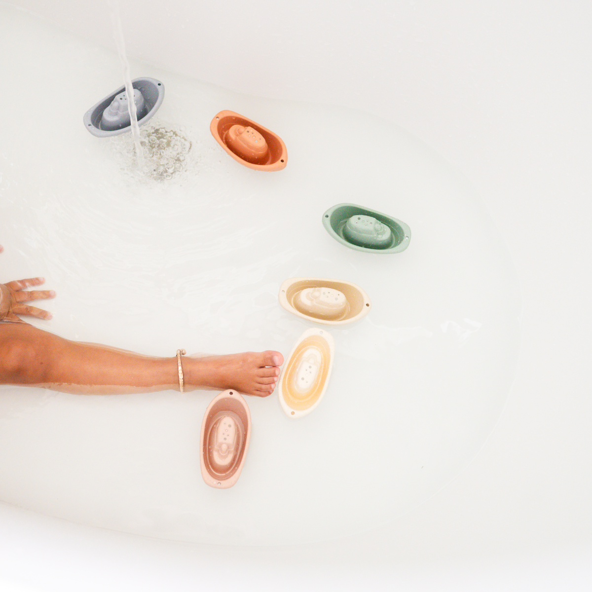 Eco-friendly wheat straw boat set by Bug + Bean Kids floating in a bathtub, perfect for sustainable and imaginative play.