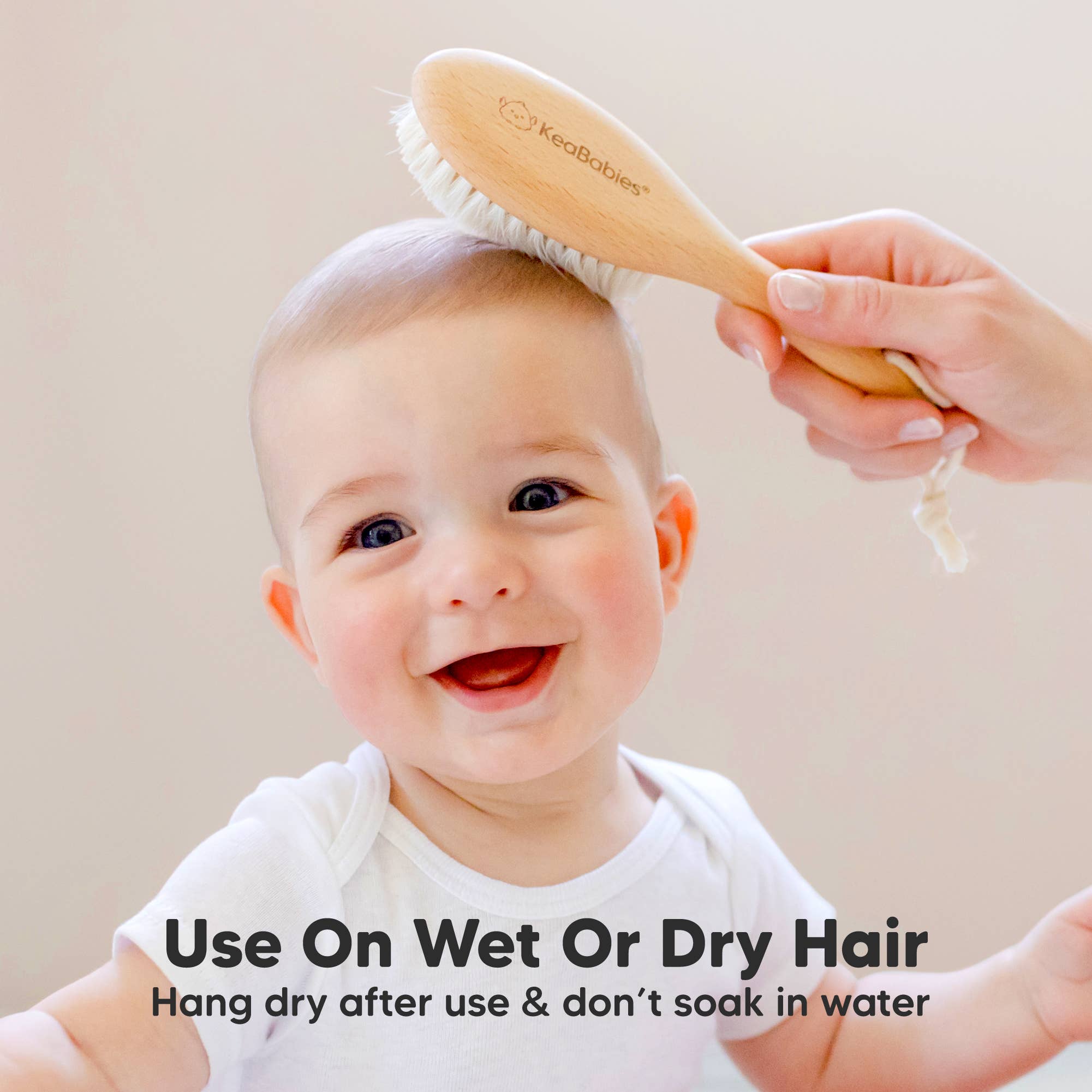 KeaBabies baby hair brush gently grooming a smiling baby, perfect for wet or dry hair care.