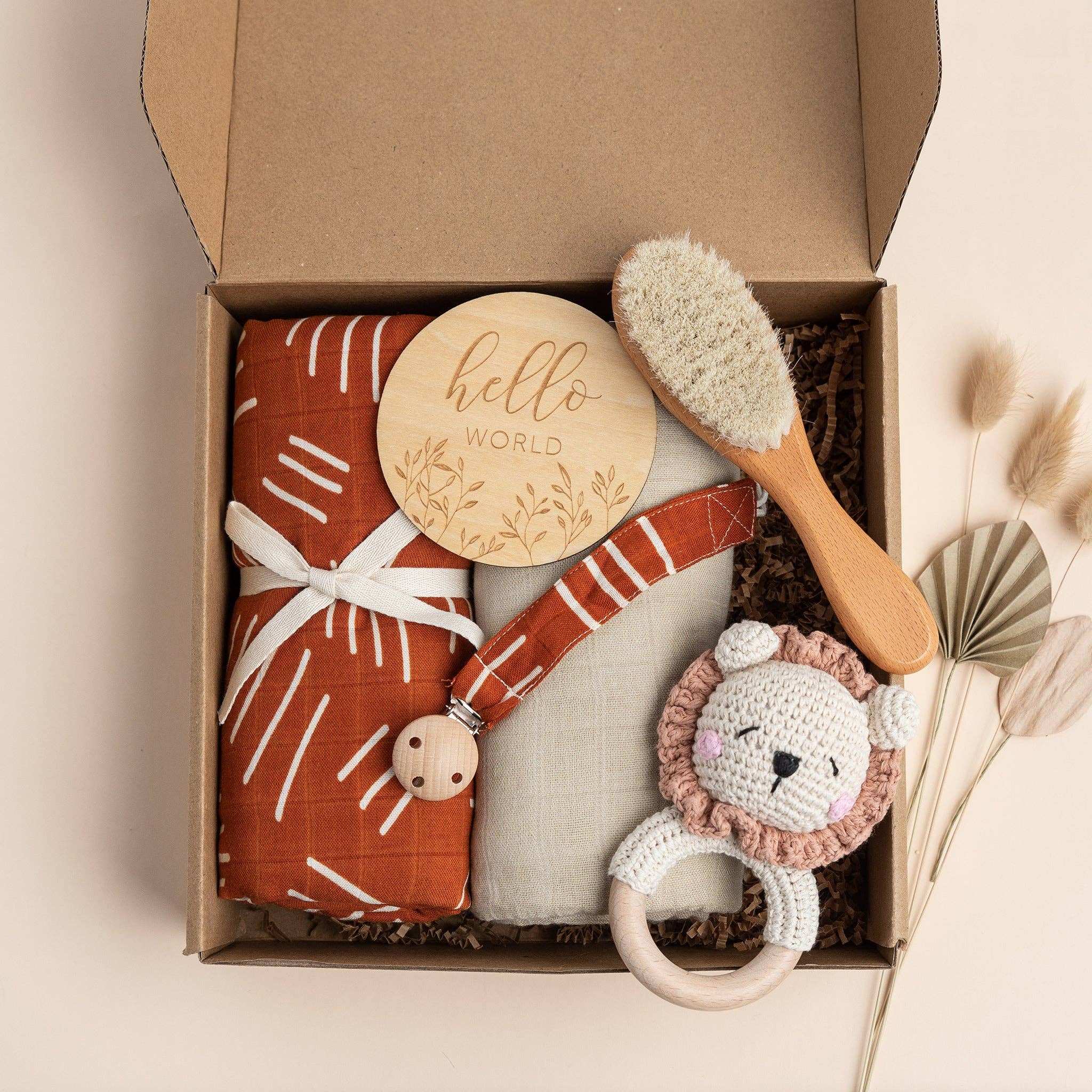 Coco Stripes Terra Deluxe Newborn Gift Set with boho designs, featuring bamboo cotton items, a rattle, and baby brush in a gift box.