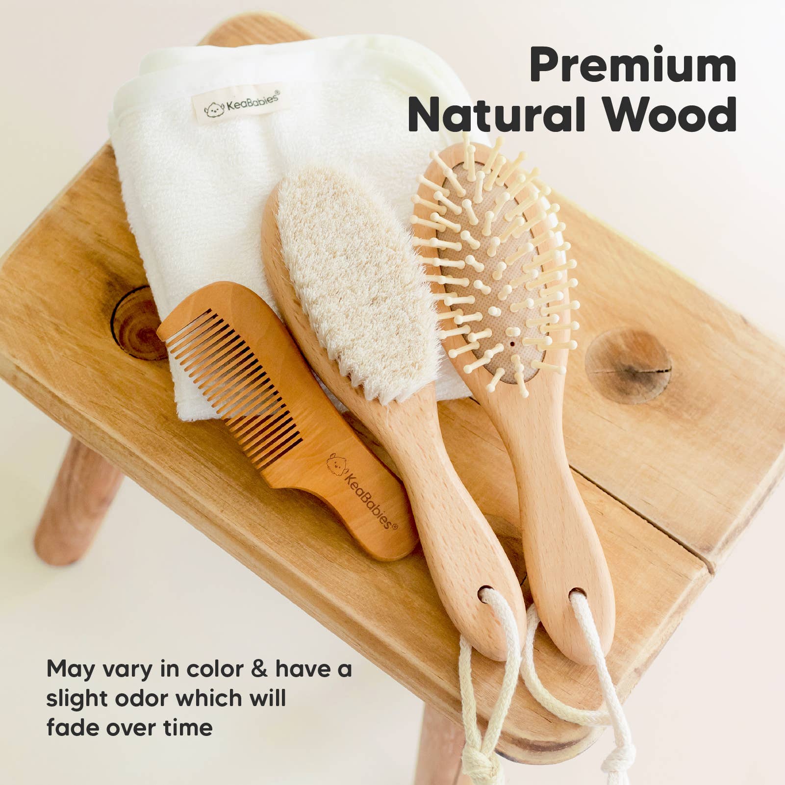 KeaBabies premium natural wood baby grooming set with brush, comb, and towel on a wooden surface.