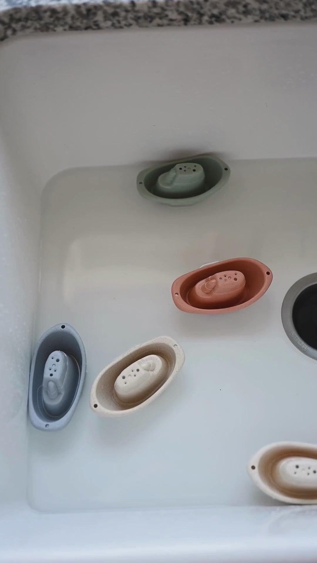 Bug + Bean Kids Wheat Straw Boat Set floating in a sink, showcasing eco-friendly and biodegradable design for playful bathtime fun.