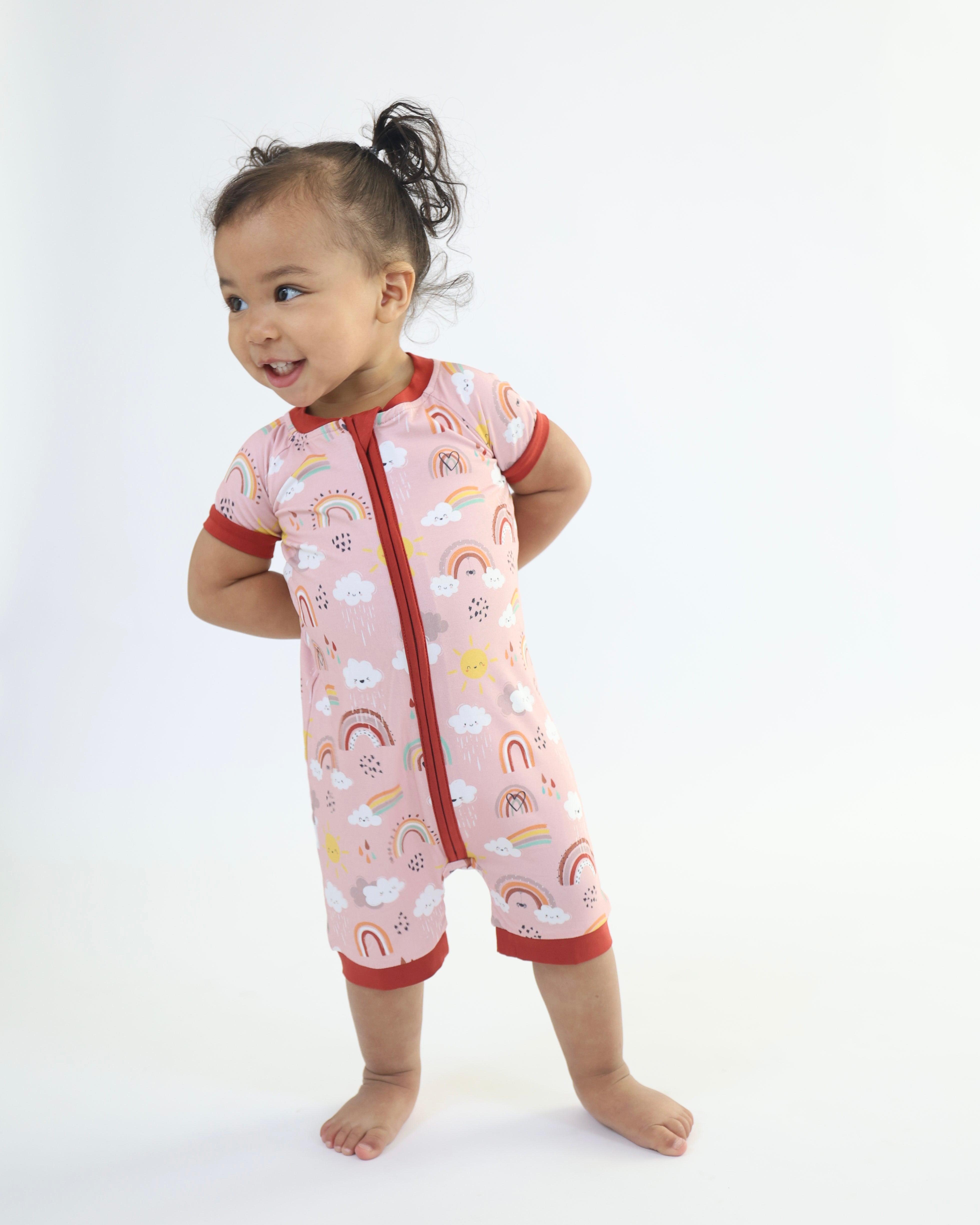 Baby wearing Bamboo Short Romper with rainbow pattern, designed for comfort and breathability. Hypoallergenic and gentle on skin.